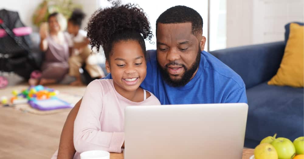 Father and daughter doing school work