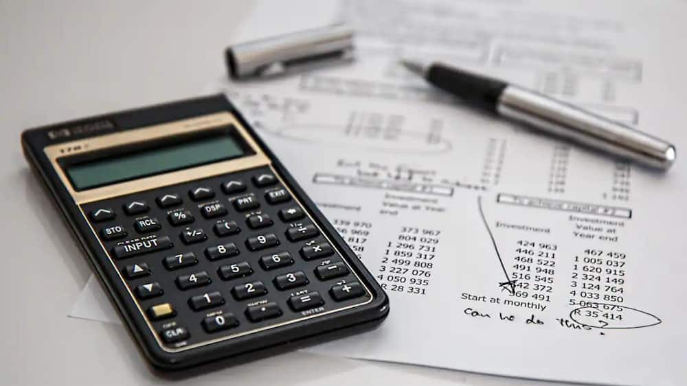 A picture of a calculator and financial sheets
