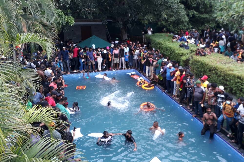 Sri Lankan protesters enjoy a swim after storming the official residence of President Gotabaya Rajapaksa Saturday Sri Lankan protesters enjoy a swim after storming the official residence of President Gotabaya Rajapaksa Saturday